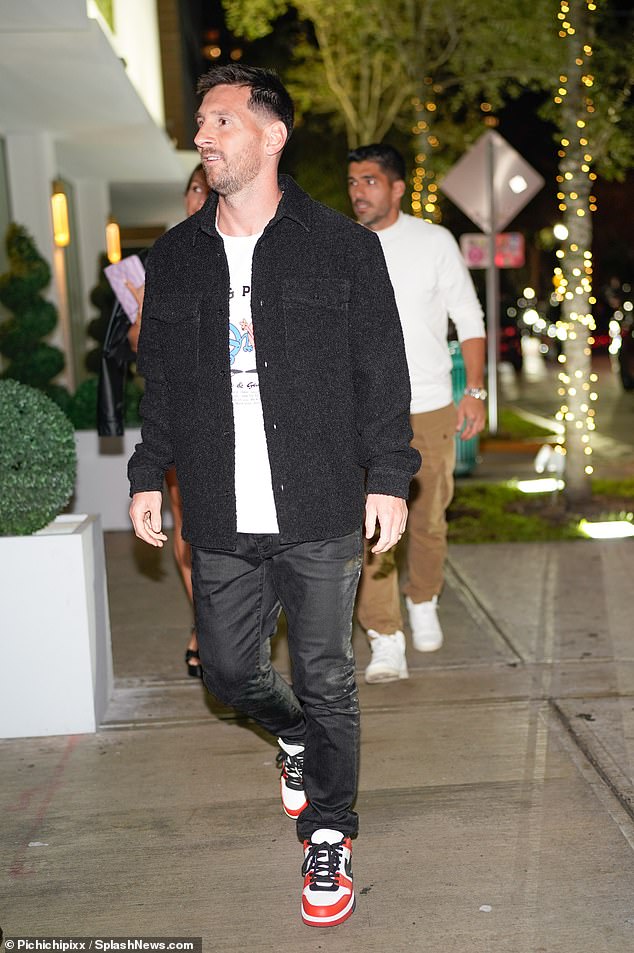 Meanwhile Messi looked effortlessly cool in a white T-shirt and an open black shirt which he teamed with black trousers and white Nike trainers