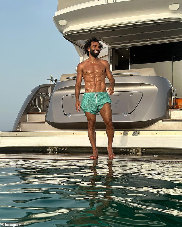 Sun and sea: Mo, pictured here about to take a dip, also shuns alcohol, which helps him maintain his chiselled look