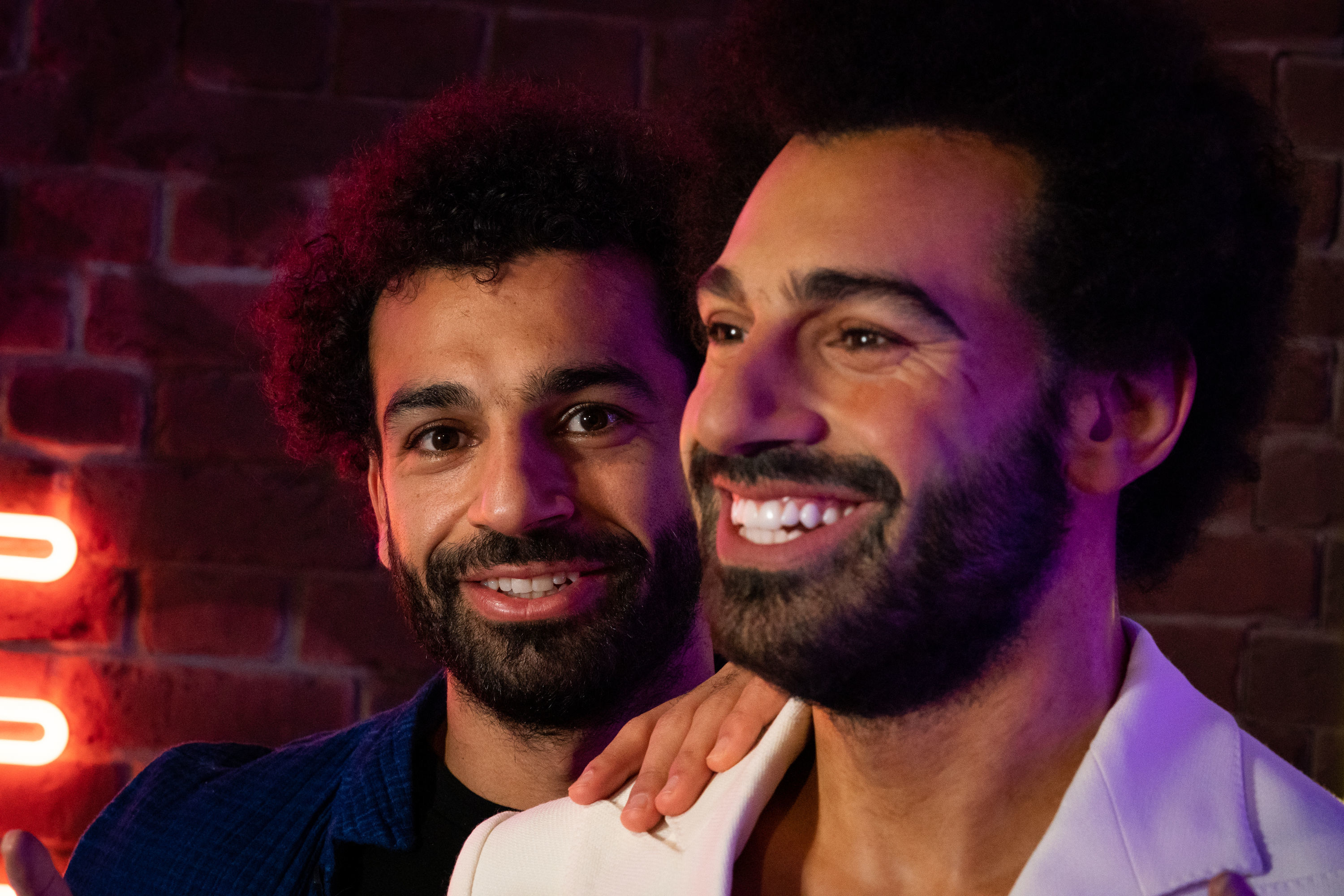 Salah cheekily checked whether his waxwork has the same abs as him